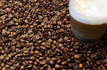 Roasted coffee beans and a cup of coffee