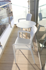 Two chairs and round table on the hotel balcony