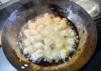 Sweet and sour pork in a wok