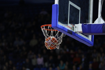 Basketball ball, board and net on black background sports hall