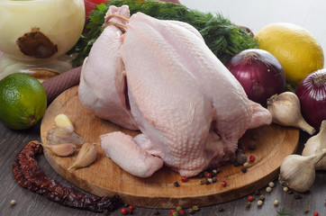 Fresh raw chicken composition on wooden background