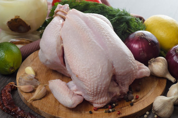 Fresh raw chicken composition on wooden background