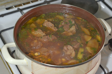 delicious meat soup, boiling on the stove. The famous Caucasian dish