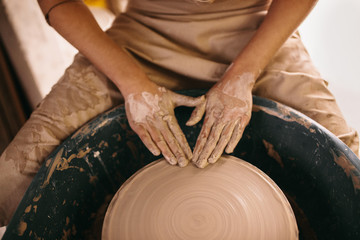 Potter moulding clay on pottery wheel