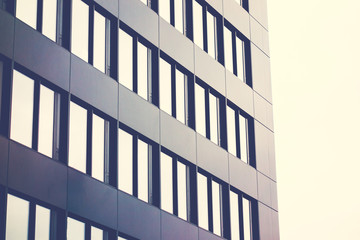 black facaded office building with mirroring windows