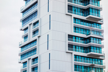 detailed view of white skyscraper with blue windows