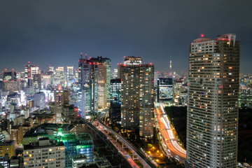 Fototapeta na wymiar View of skyscraper and glowing light traffic in downtown at night