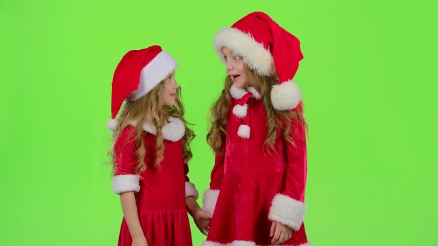 Two children are talking about the celebration of the new year. Green screen. Slow motion