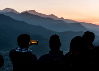 Silhouettes of men at sunset, Pokhara, Nepal.