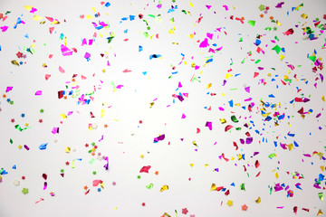 colourful sparlking confetti on white background