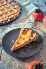 Slice sweet pie with persimmon fruits