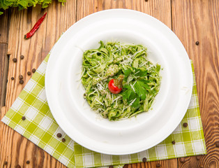 Tagliatelle pasta with spinach and green peas pesto, selective focus