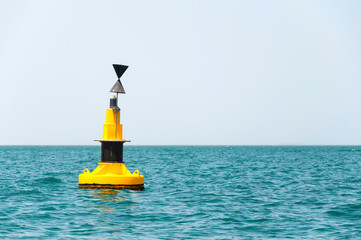 floating yellow buoy on blue sea - Powered by Adobe