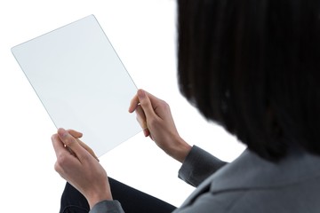Female executive using a glass digital tablet
