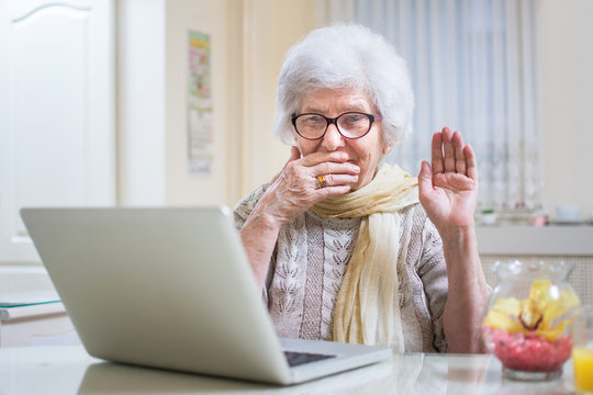 Shocked Senior Woman Using Laptop At Home.