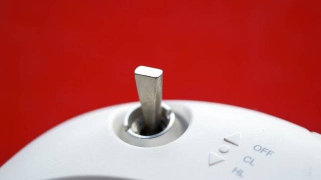 3 Position rocker switch or single pole toggle switch. Male hand turning on-off RC remote control switch. Engine control unit ECU. Close up, Shallow depth of field