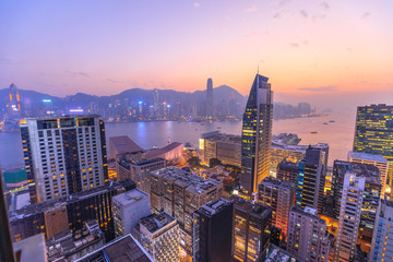 Vue aérienne spectaculaire du port de Victoria, des gratte-ciel et des toits de Hong Kong la nuit.