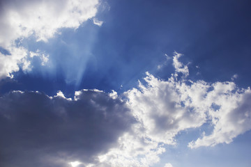 Horizontal photo of a beautiful blue sky rich in clouds and sunlight beam