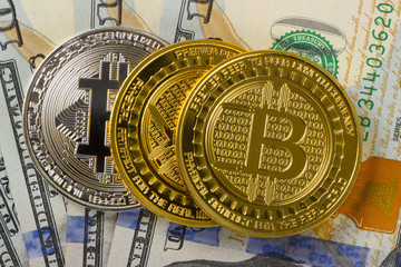 Coins bitcoin on a background of 100 American dollars close-ups