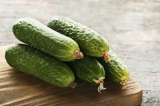 Fresh cucumbers on grey wooden table