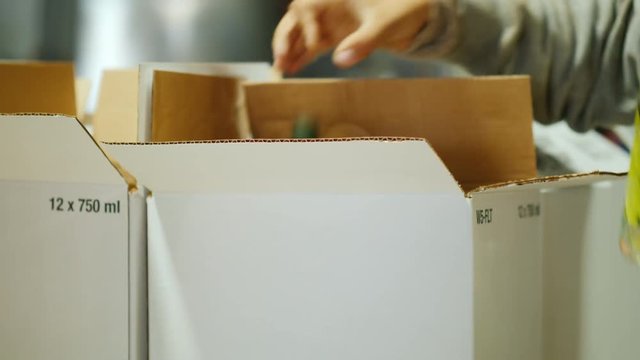 Stack bottle of wine in boxes. Working in the winery