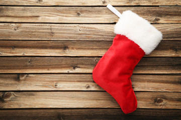 Obraz na płótnie Canvas Christmas stocking on brown wooden table