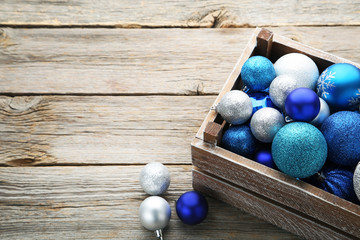 Blue and silver christmas baubles in wooden crate