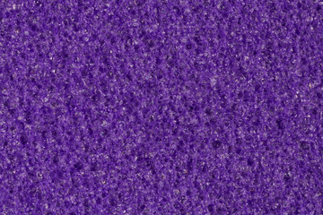 Dark violet foam (EVA) texture with contrast porous surface.