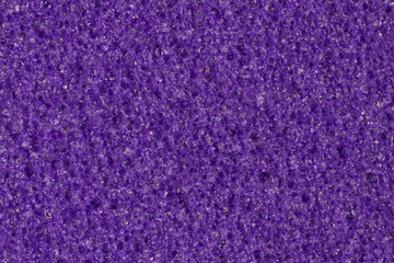 Dark violet foam (EVA) texture with contrast porous surface.
