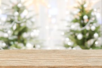 abstract blurry beautiful of decoration Christmas tree background with plank wooden texture floor for show,advertise,promote product concept