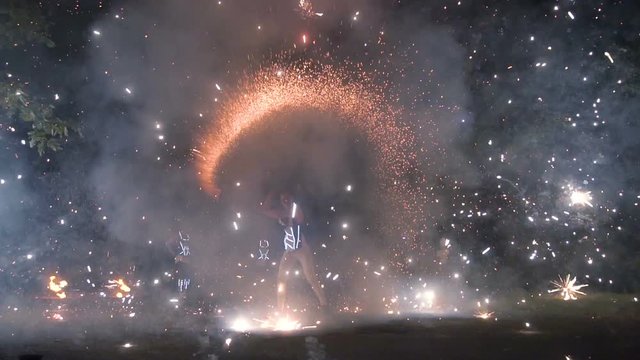 Large firework sparks burning at night fire show. Slow motion