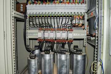 High-power capacitors installed in the electric box - obrazy, fototapety, plakaty