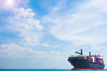 ship with container vessel carry big tank shipping goods  on blue sky background for logistic and transportation concept.