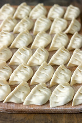 Many raw Jiaozi or Gedza Chinese dumplings, common in East Asia.