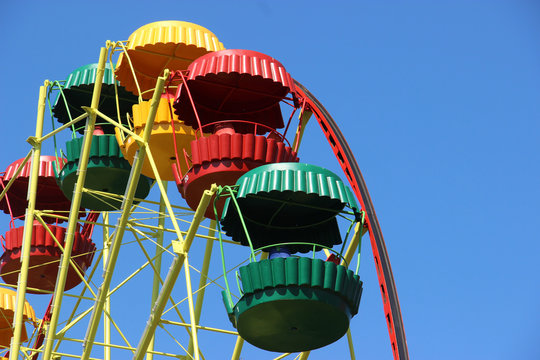 Retro colored Ferris Wheel on Blue Sky. Copy space for text.