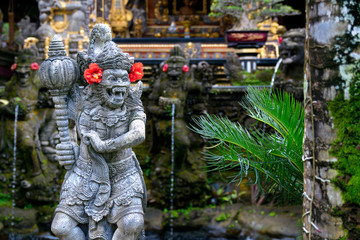 Fototapeta na wymiar figure of warrior in balinese arquitecture in beautiful eden garden in bali. indonesia