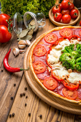 Italian pizza with cheese, on a wooden table