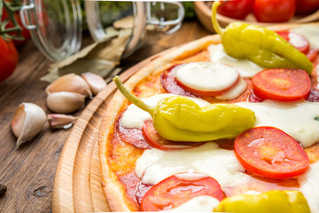 Italian pizza with cheese, on a wooden table