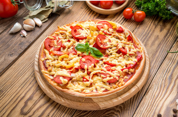 Italian pizza with cheese, on a wooden table