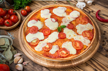 Italian pizza with cheese, on a wooden table