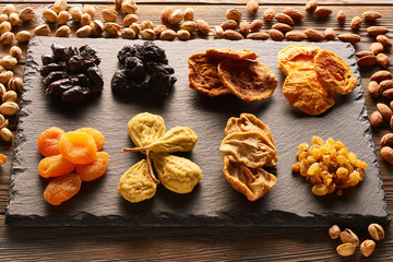 Dried fruits and nuts on slate plate