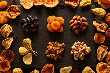 Obraz na płótnie Canvas Dried fruits and nuts on slate plate