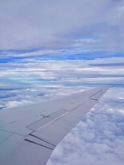 Fototapeta na wymiar Blue skies, happiness, airplane, wing, travel, journey