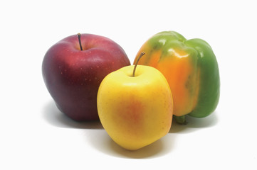 Two apples and one green pepper on the white background.