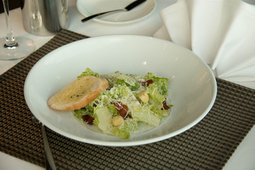 A plate  caesar salad with croutons