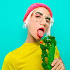 Cute Blonde Model in stylish accessories. Beanie and glasses. Fashion bright look