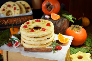 Shortbread cookies shaped as a ring decorated with dried cherry and nuts. Christmas festive treats
