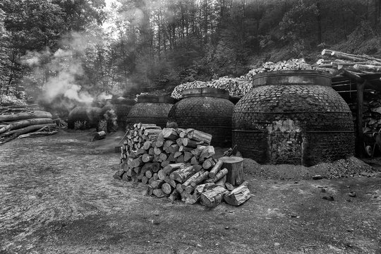 The production of charcoal in a traditional manner in the forest