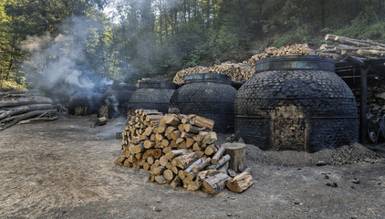 The production of charcoal in a traditional manner in the forest