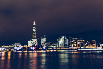 Fototapeta na wymiar Long exposure shot of modern London cityscape skyline with shard building at night